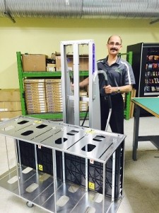 Makram using an Aluma Lift device to move around magazines from PROMATION Inc. that are automatically loaded with finished LED assemblies.